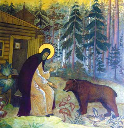 Святой кормит медведя